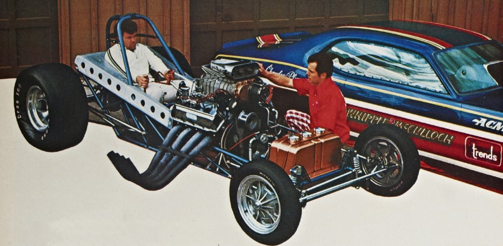 Art Whipple seated in an early dragster chassis beside a Whipple-McCulloch car.